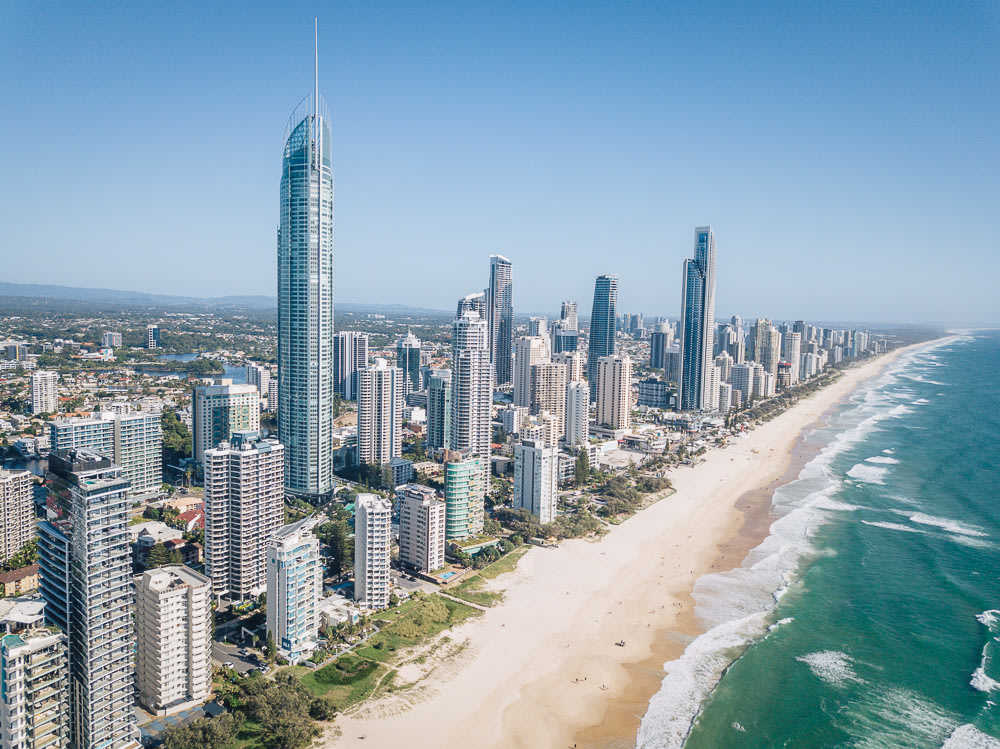 The Gold Coast skyline juxtaposed to the sand and beach of Surfers Paradise