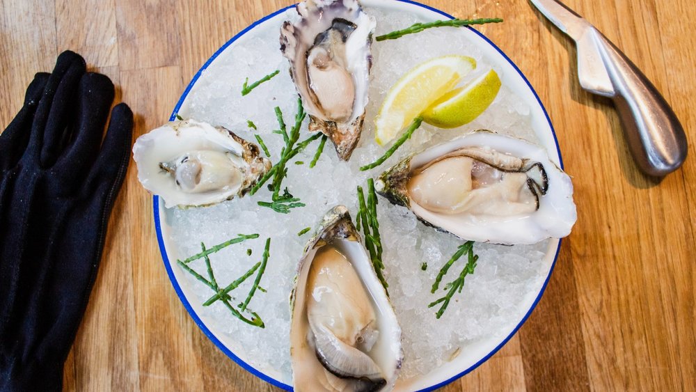 A delectable plate of oysters served at the local oyster farm. Credit: Louis Hansel @shotsoflouis on Unsplash