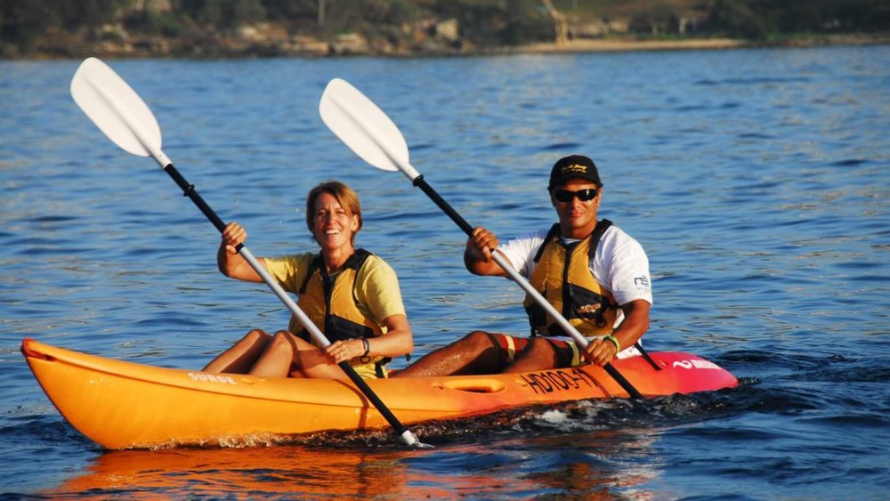 Tandem kayaking in the crystal clear waters of Manly