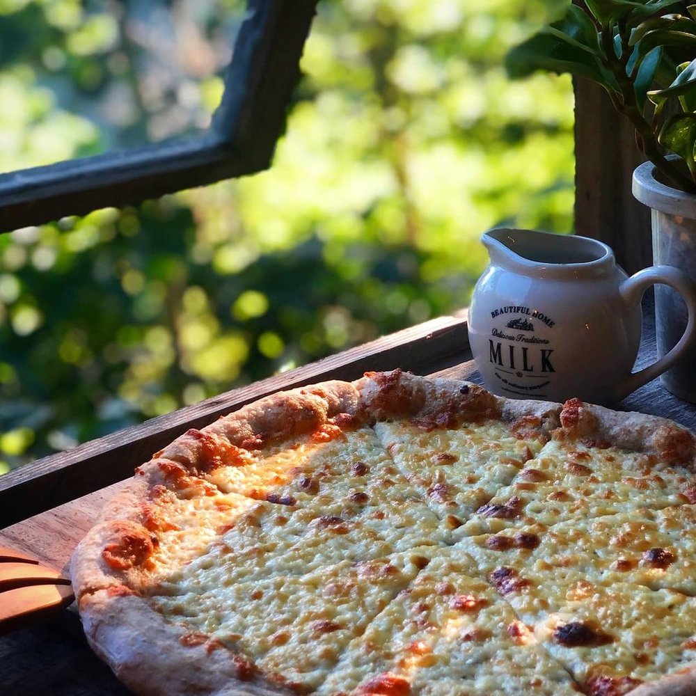 cheese pizza and coffee by window