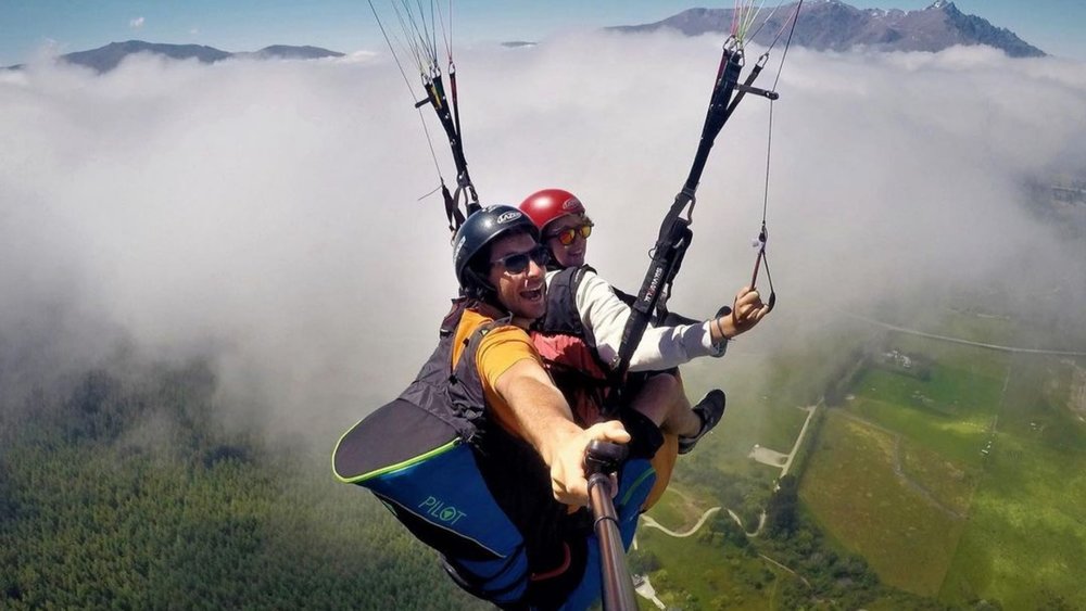 Reach for the clouds when you go paragliding at Coronet Peak! Credits: @coronetpeaktandems