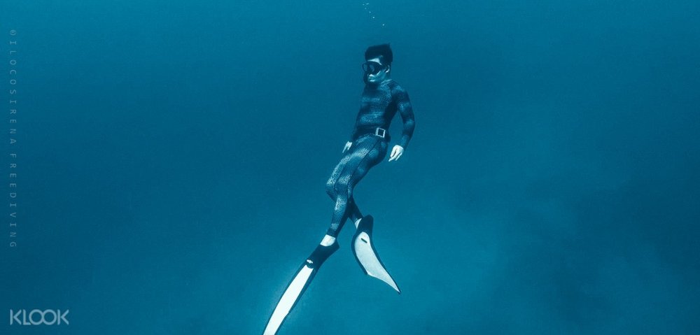 kid underwater wearing diving gear