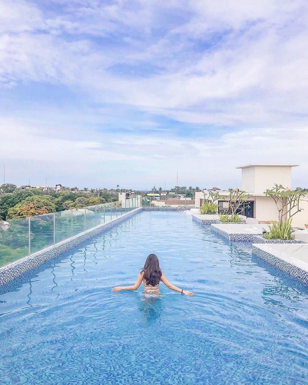 woman in a pool on top of Ferra Hotel and Garden Resort