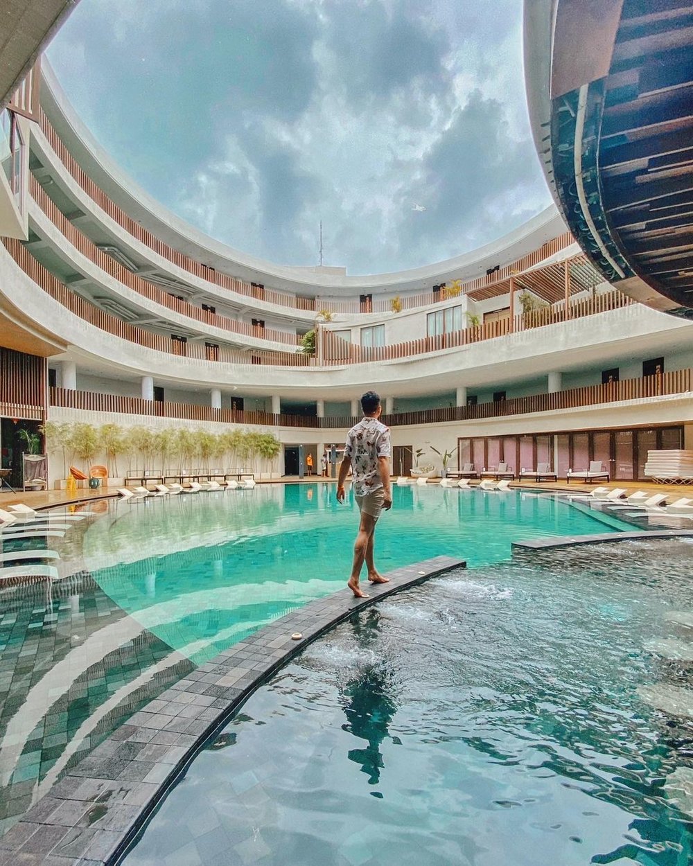 man standing by the hue hotel and resorts pool in boracay
