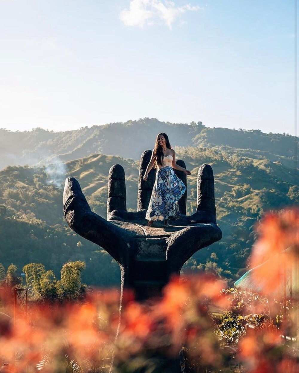 girl posing in hand statue in sirao pictorial garden 