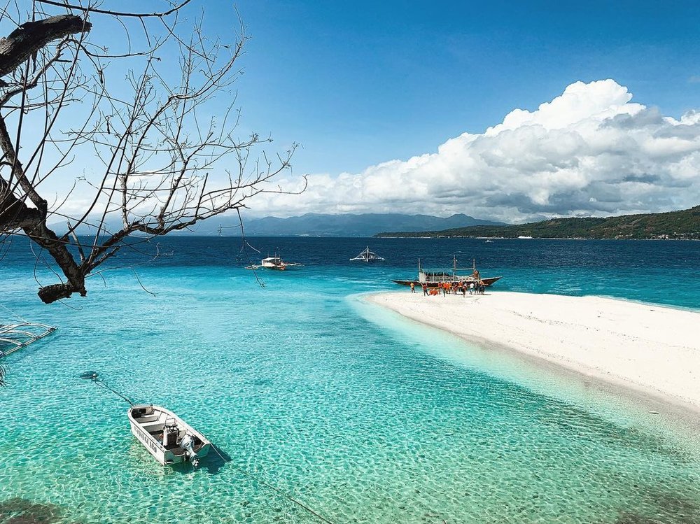 a view of Sumilon Island's sandbar and nearby boats