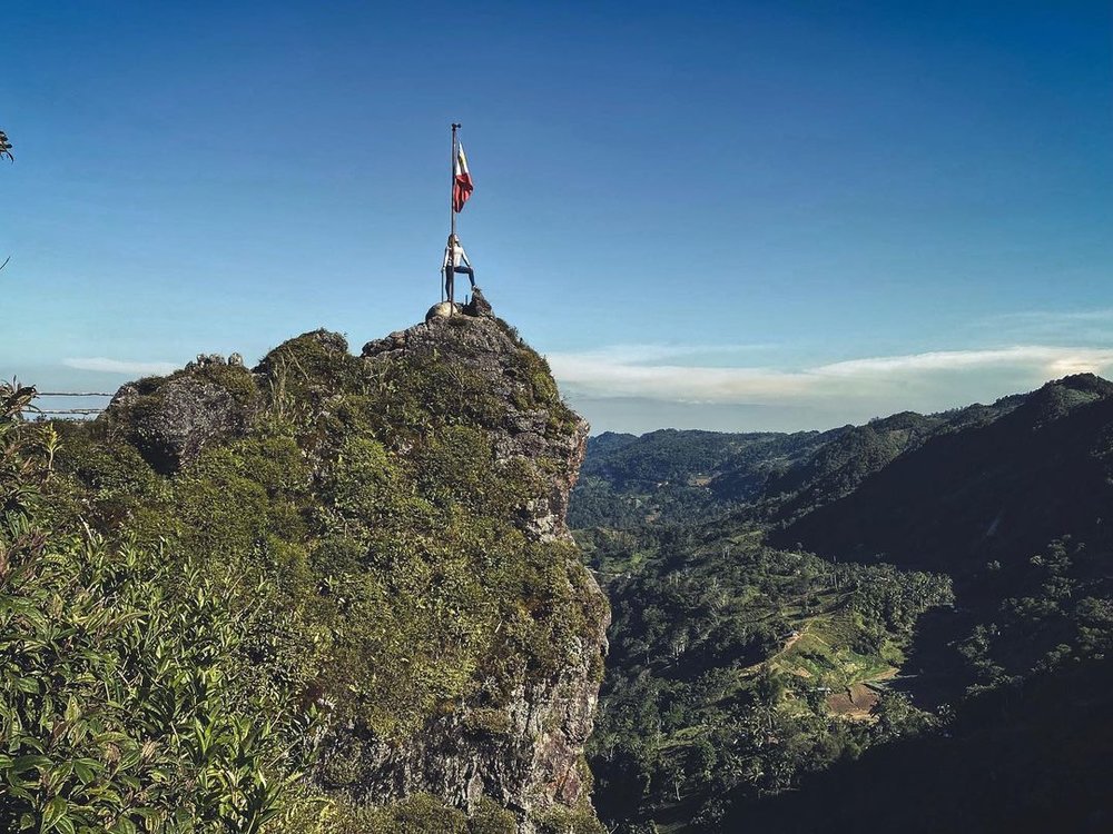 woman standing on Kandungaw Peak's highest point