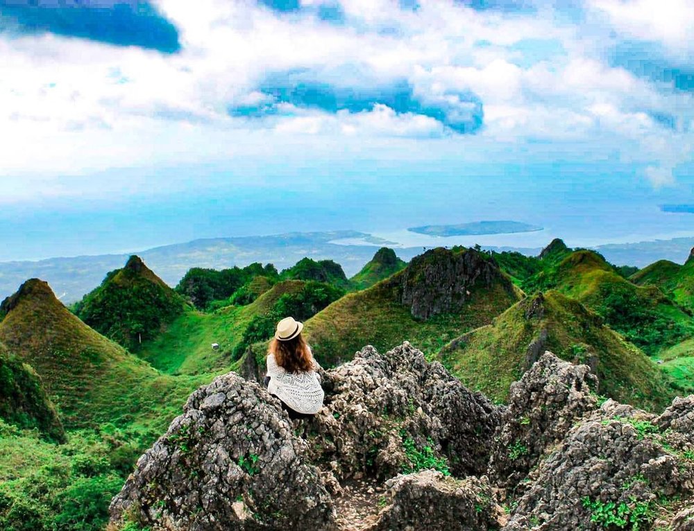 woman on top of rocks somewhere in Osmena Peak