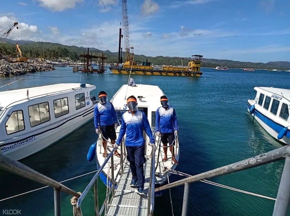 three men on speedboat on the way to boracay island