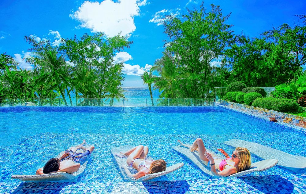 three people in blue pool in accredited boracay hotel