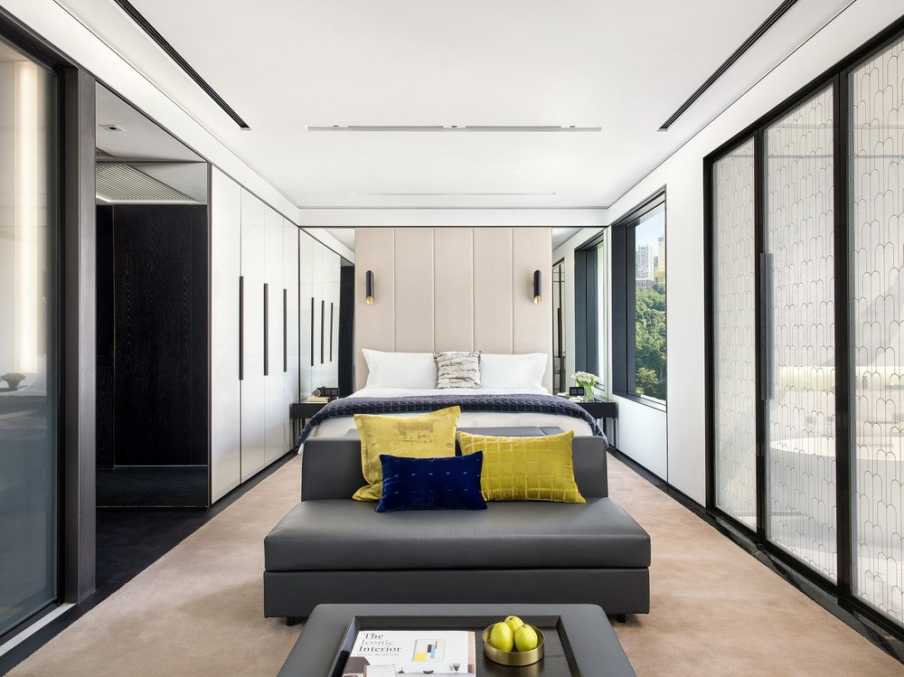 bedroom with grey couch and blue and yellow pillows at murray hong kong