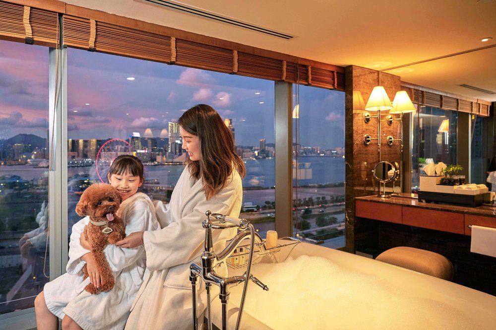mom and daughter with brown poodle in bathroom of mandarin oriental hong kong