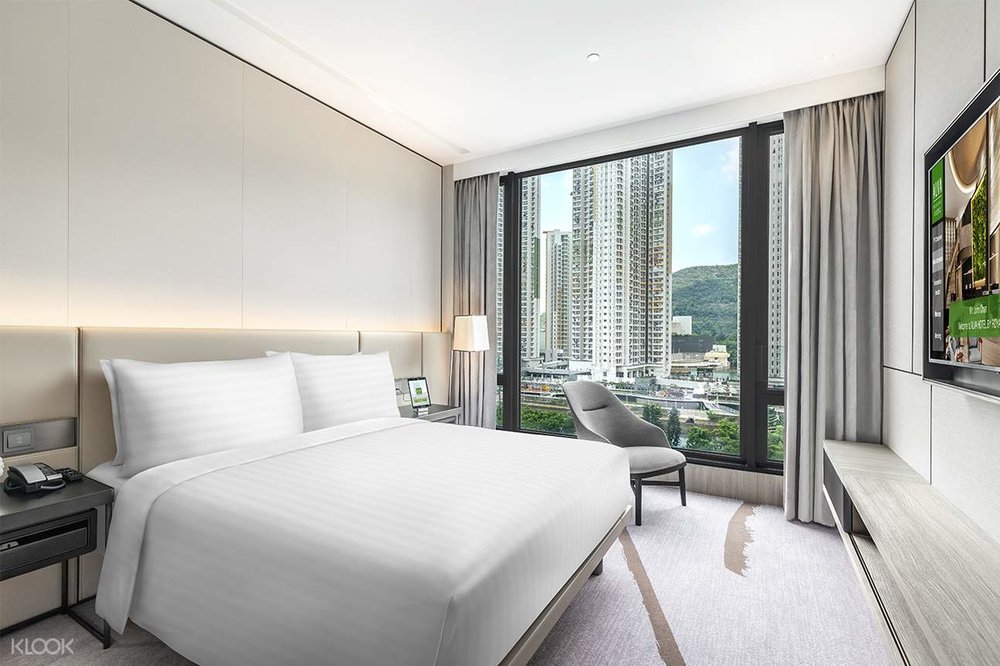 white guest room with city views at alva hotel by royal