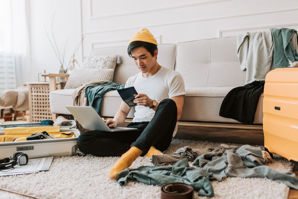 man using laptop preparing travel documents