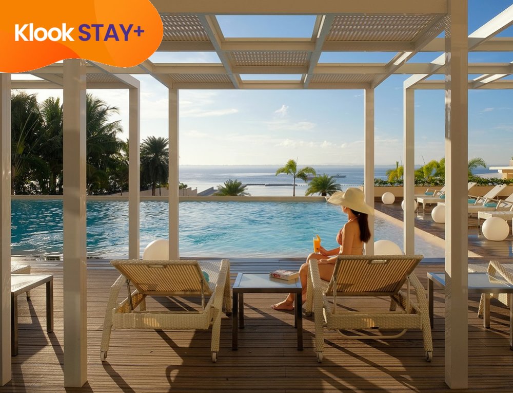 woman sitting by pool sunset at be resorts mactan