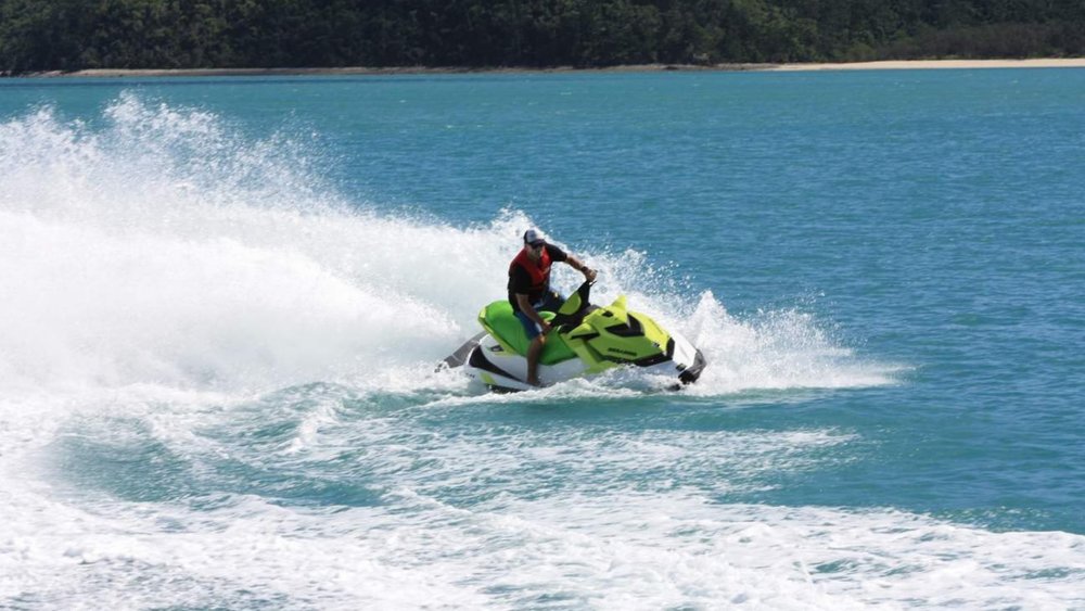 Ride through the turquoise waters of the scenic Airlie Beach