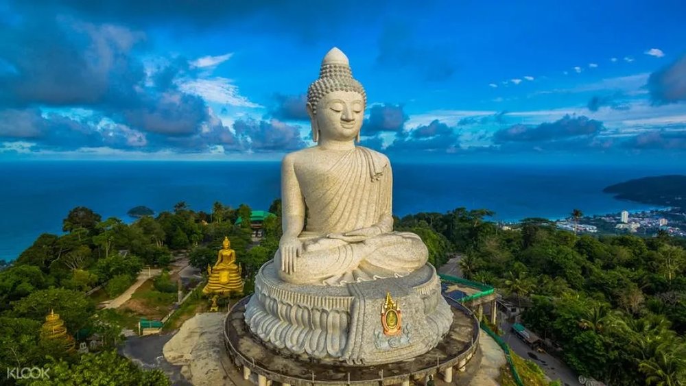 huge statue of buddha on top of a hill