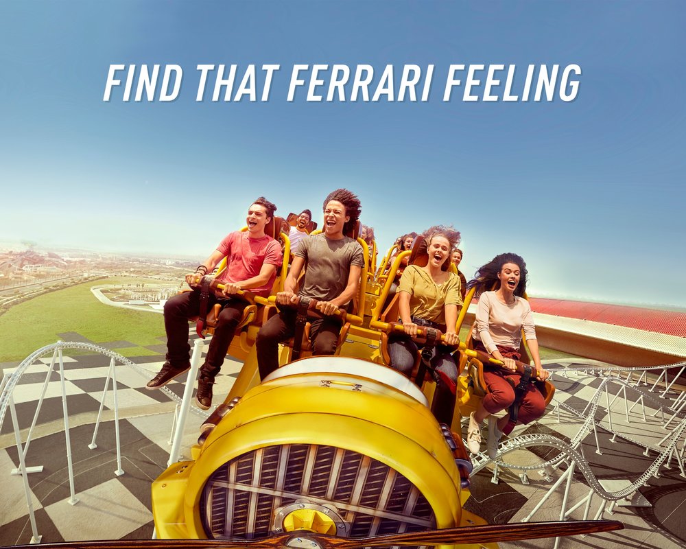 people riding a roller coaster at ferrari world