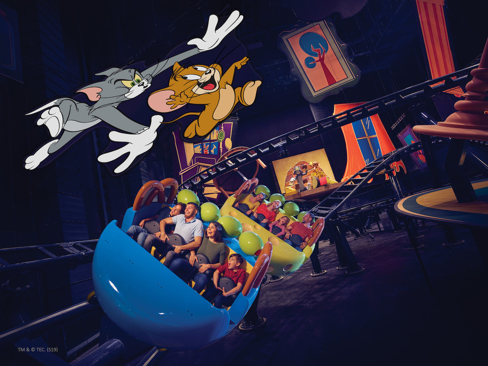 family riding an attraction at warner bros