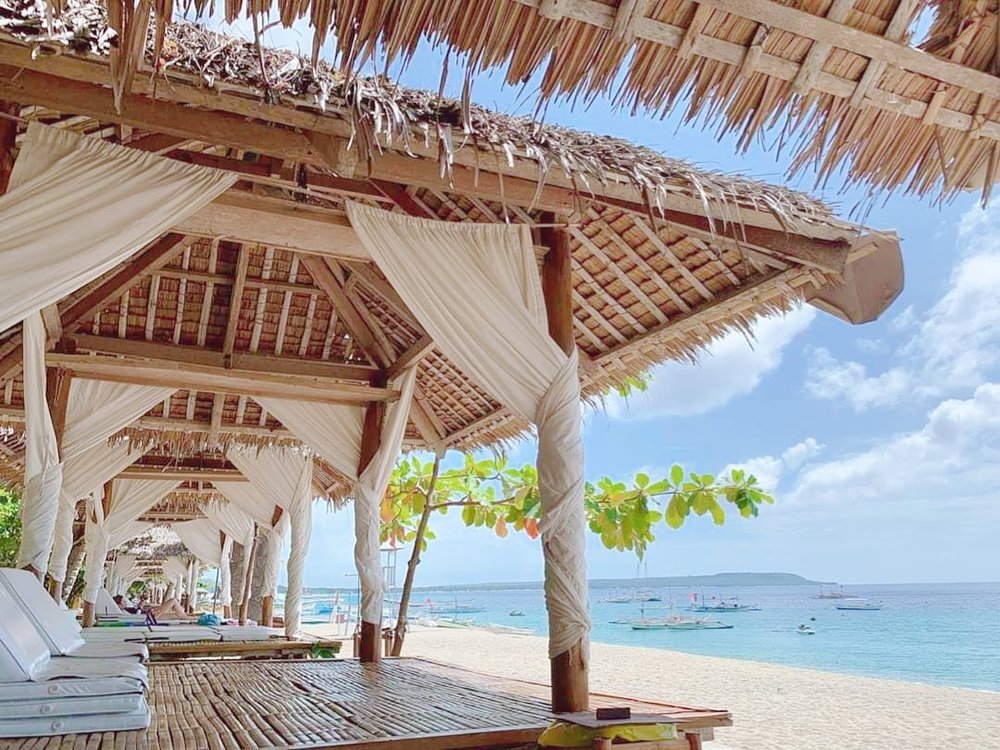 bamboo chairs on beach at la luz beach resort batangas