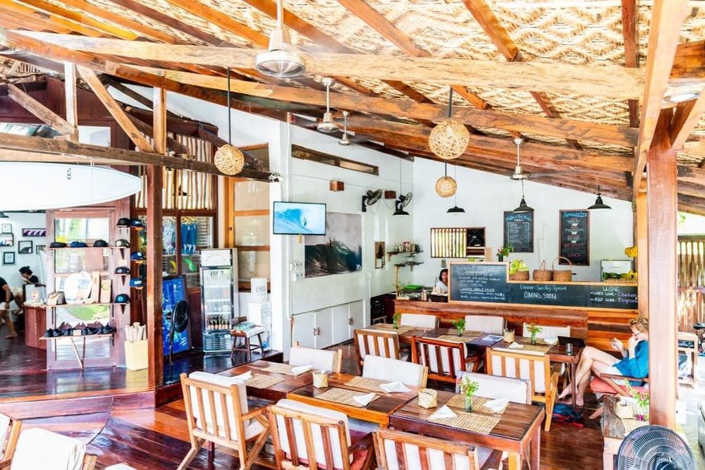 wooden cafe dining chairs and table in greenhouse siargao cafe