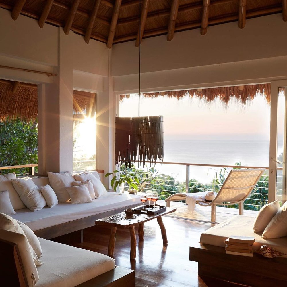 white lounge area overlooking beach at diniview villas boracay