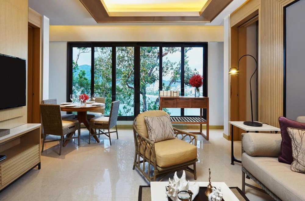 a living room and dining area in an Amari Phuket Suite
