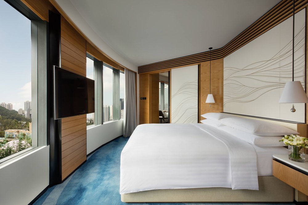 king bed with windows at ocean park marriott hotel
