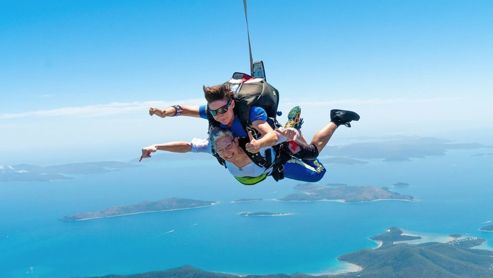 Get a bird’s eye view of the white sand and blue waters of Airlie Beach. Image credits: @skydiveaustralia on Instagram