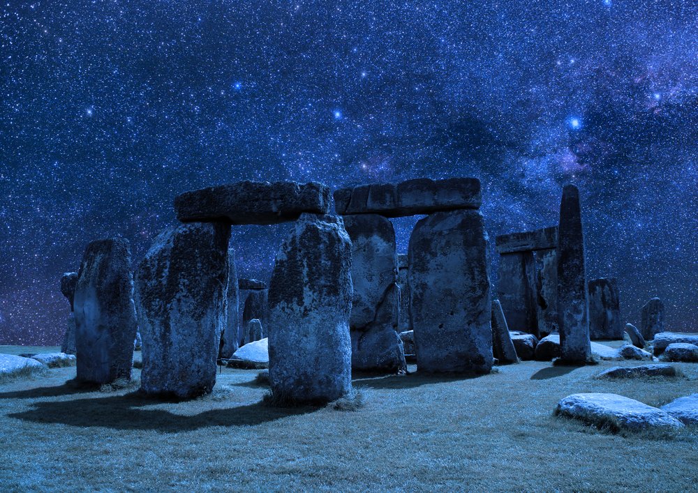 stonehenge at night, illuminated by stars