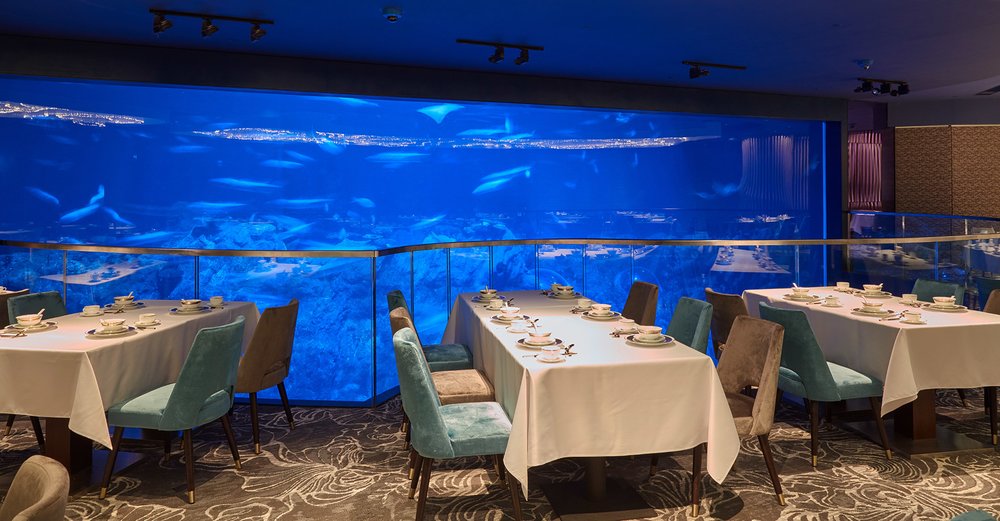 tables and aquarium in neptune's restaurant in ocean park hong kong