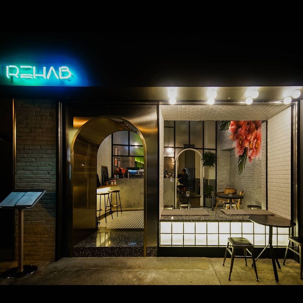 門口以金屬圓拱門和白色燈箱設計,吸引不少客人。(Instagram @rehab.cafebar)