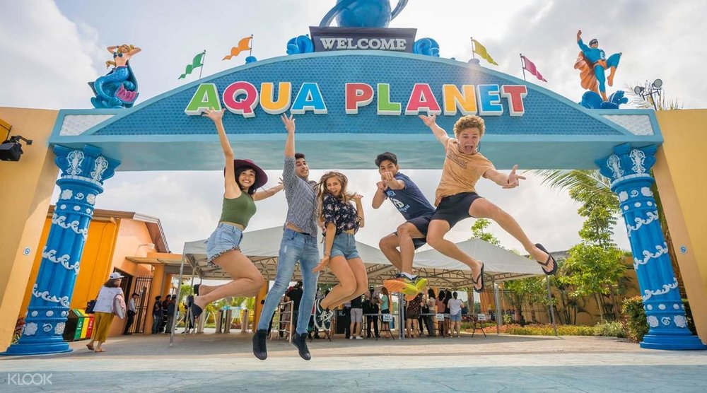 kids jumping at aqua planet entrance
