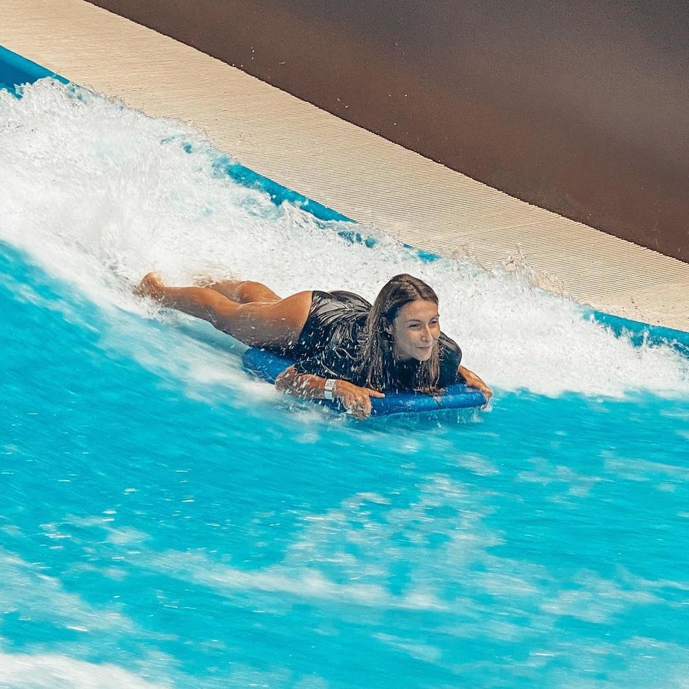 woman on surfboard at surf striker water world hk