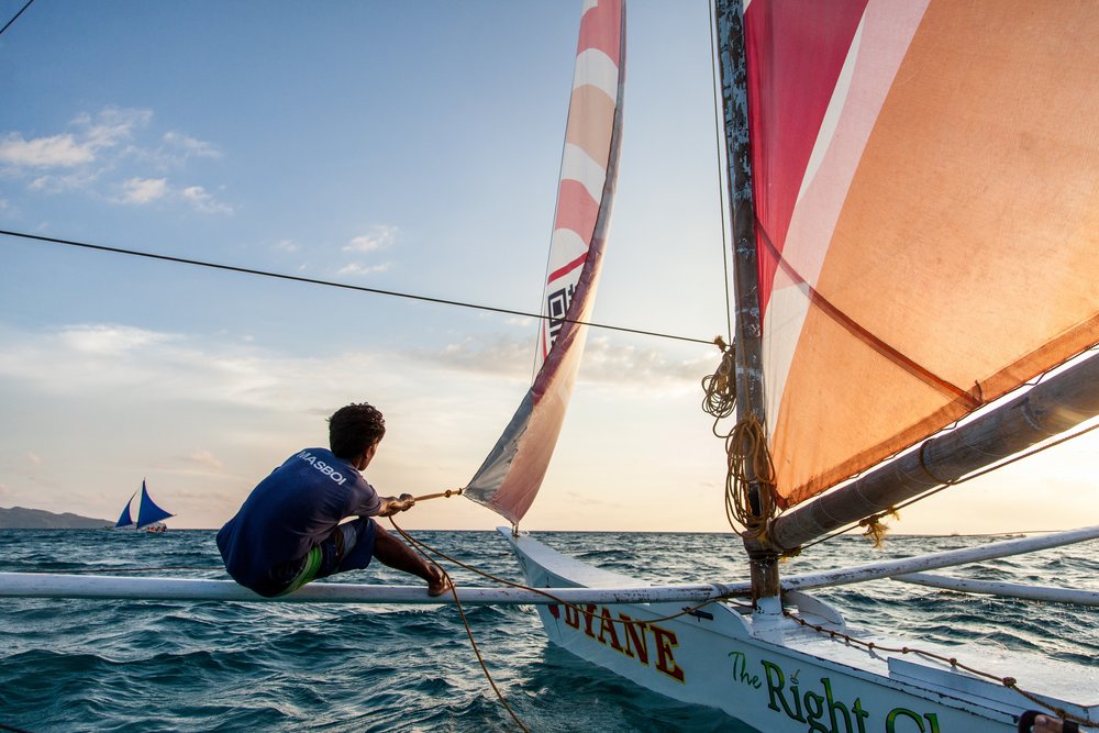 man with a boat in the ocean