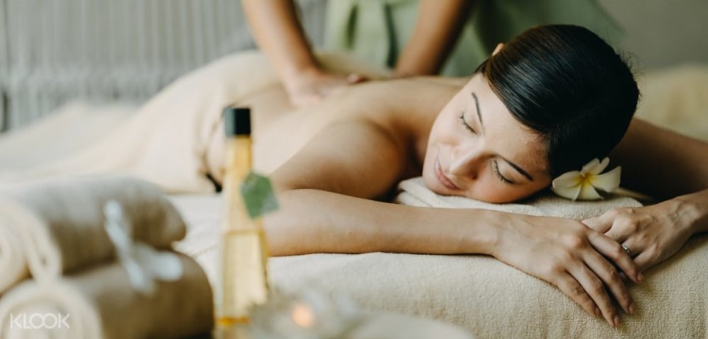 woman lying down getting a back massage