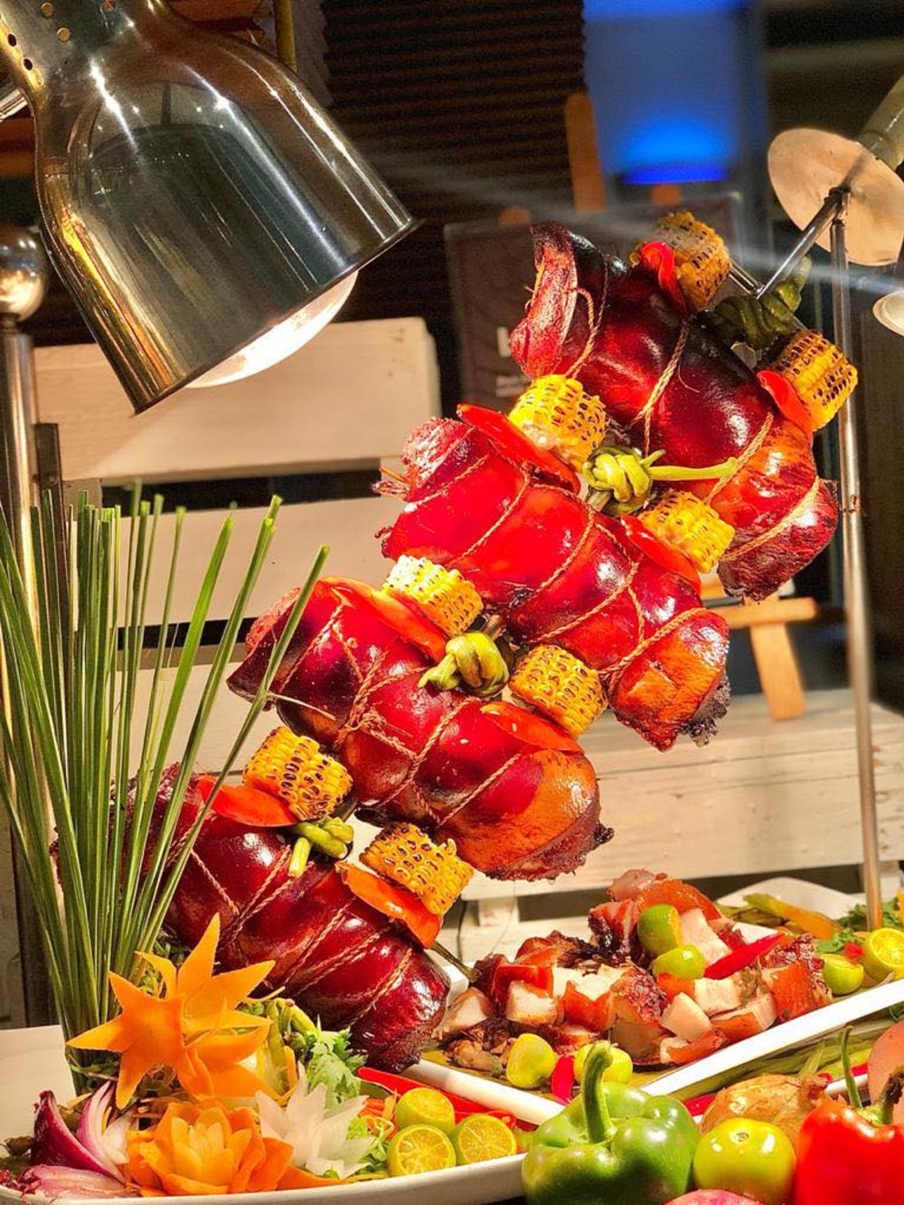 hotel buffet with meat skewers and corn