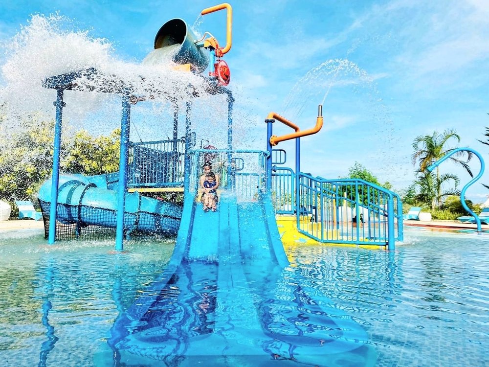 mother and daughter sliding down water slide