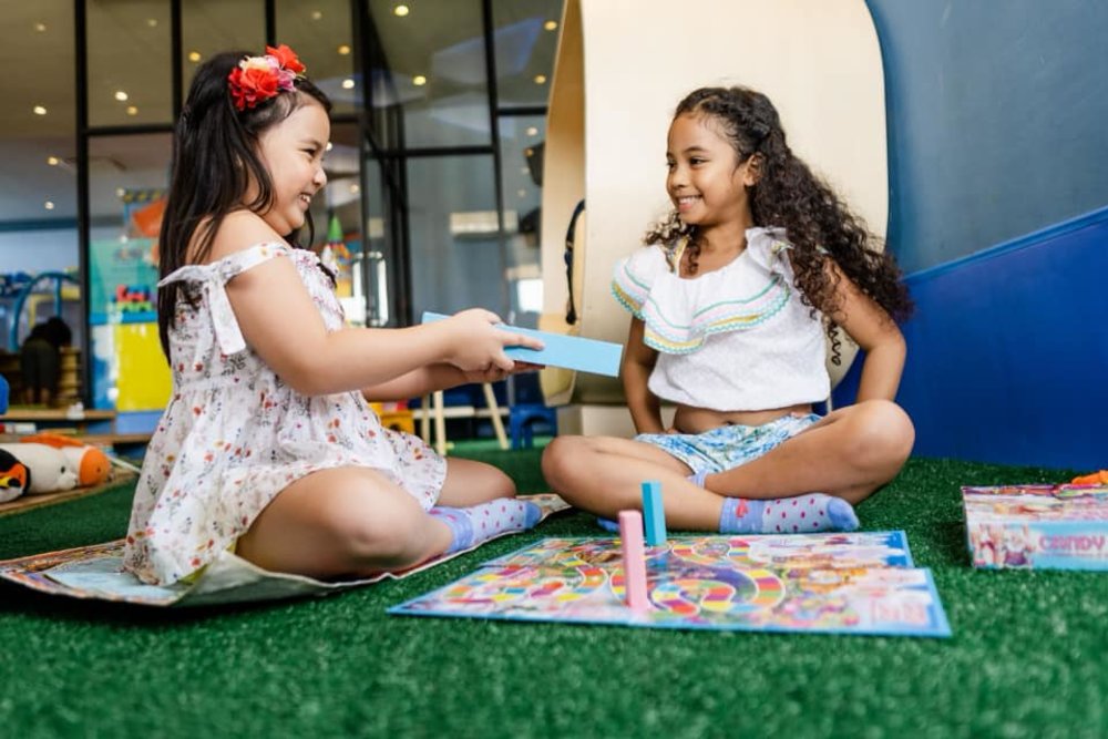 two kids smiling and playing together