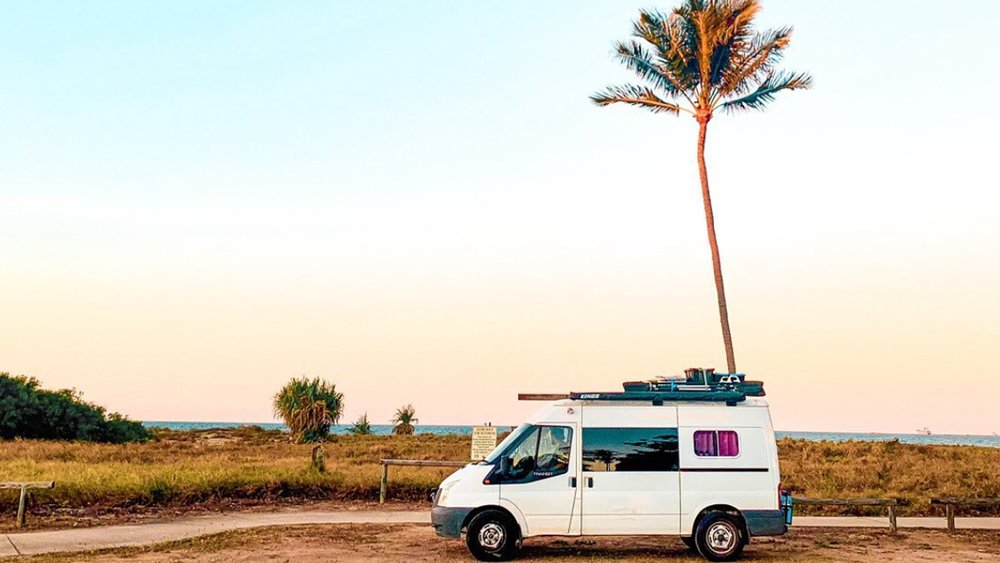Enjoy the views of palm trees and the oceanside on your road trip to Whitsundays. Credit: @_lapofthemap