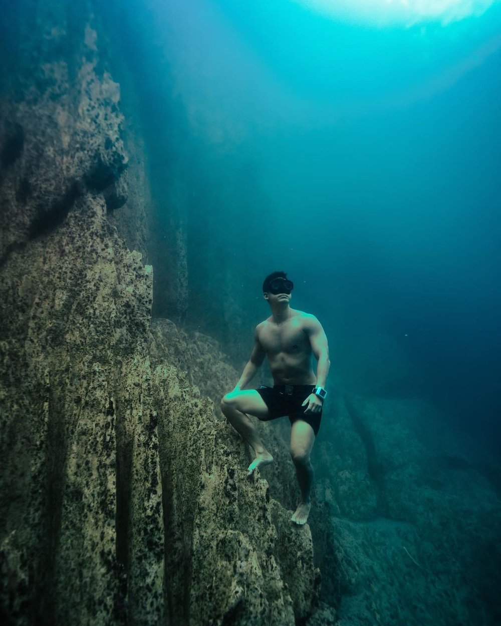 man diving in underwater lake