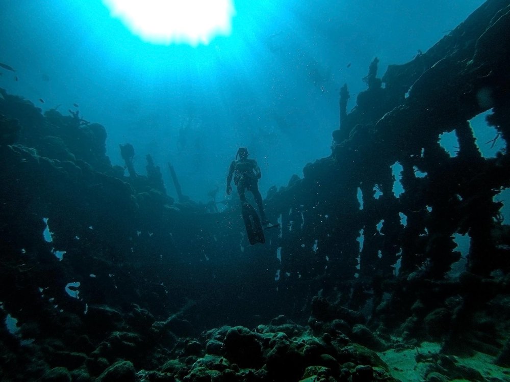 scuba diver in the middle of shipwreck