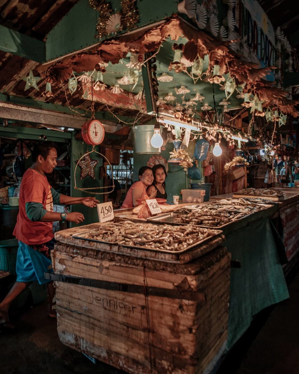 two women smiling in a local fish market