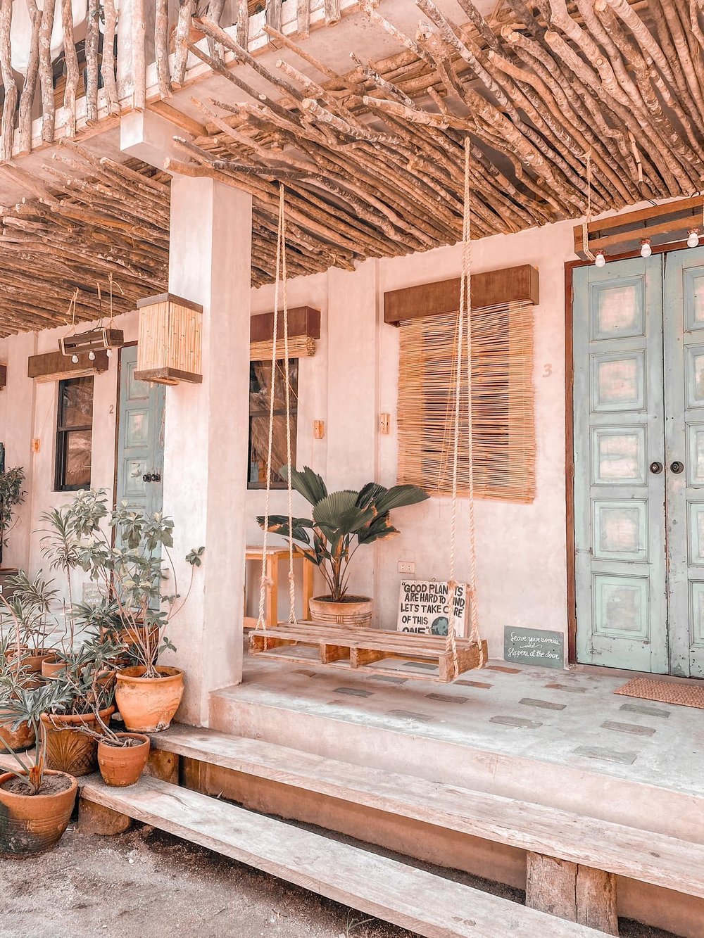 wooden swing in entrance with blue door