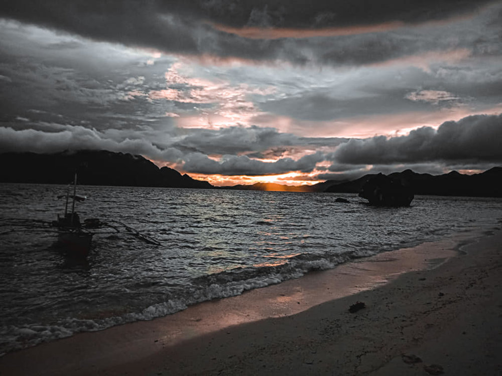 beach sunset partially obscured by clouds