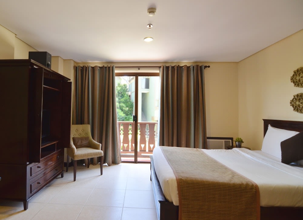 hotel room with queen bed and huge cabinet