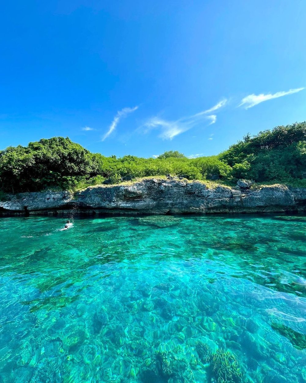 blue green waters and rocky cliff