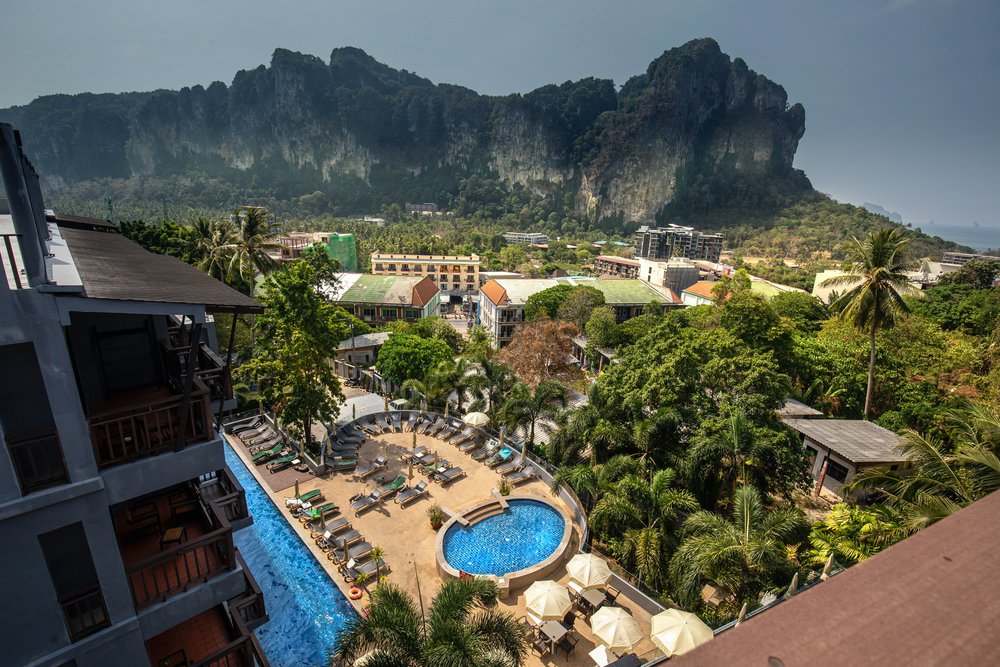 a view of a pool from a hotel balcony in Thailand
