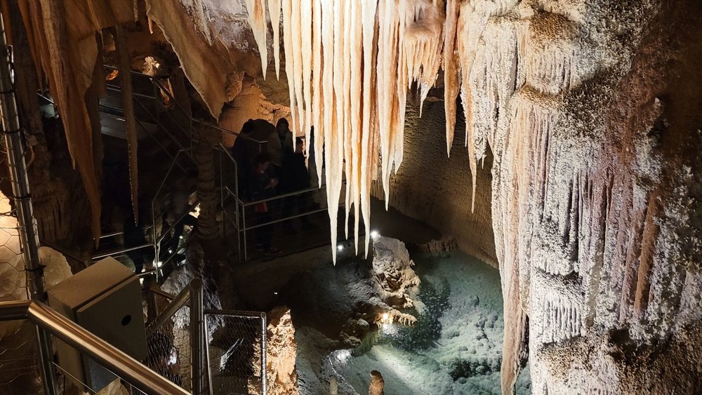 Stalactite formations and limestone crystals hang in the halls