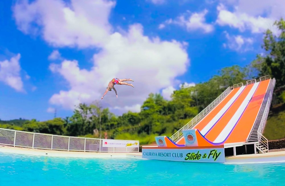 man jumping from water slide